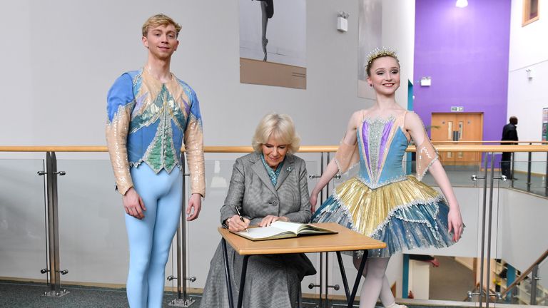 The Duchess of Cornwall signs the visitors' book alongside young ballet dancers during a visit to Elmhurst Ballet School in Birmingham. PA Photo. Picture date: Wednesday January 22, 2020. See PA story ROYAL Camilla. Photo credit should read: Anthony Devlin/PA Wire