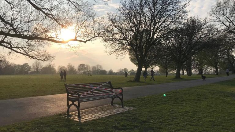 A bench is cordoned off in a London park, amid fears that the pleasant weather over the Easter weekend could stop people staying home.