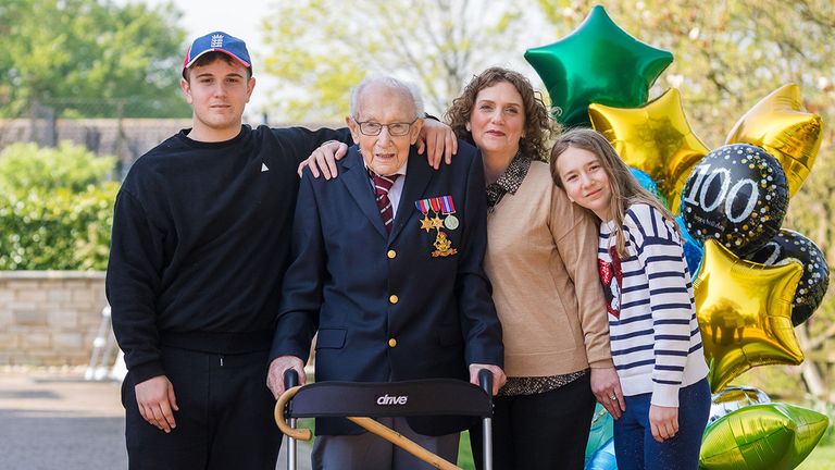 Mandatory Credit: Photo by VICKIE FLORES/EPA-EFE/Shutterstock (10614773y).99-year-old British veteran Captain Tom Moore (2-L) with with grandson Benji (L), daughter Hannah Ingram-Moore (2-R) and granddaughter Georgia (R) outside his home after completing the 100th length of his back garden in Marston Moretaine, Bedfordshire, Britain, 16 April, 2020. Captain Tom Moore has raised over ..12 million for Britain's National Health Service (NHS) and has received donations to his fundraising challenge from around the world..British veteran raises millions for NHS by walking lengths of back garden, Marston Moretaine, United Kingdom - 16 Apr 2020