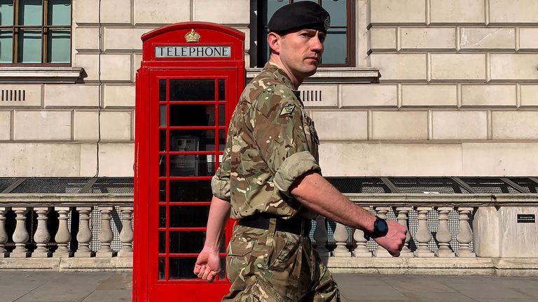 A member of the military walks past a phone box in Westminster, central london, on April 15, 2020 as Britain continues to enforce a nationwide lockdown to halt the spread of COVID-19. - The new leader of Britain&#39;s opposition Labour Party urged the government today to set out how it plans to end the coronavirus lockdown, both to give people hope and avoid "mistakes" of the past. (Photo by DANIEL LEAL-OLIVAS / AFP) (Photo by DANIEL LEAL-OLIVAS/AFP via Getty Images)