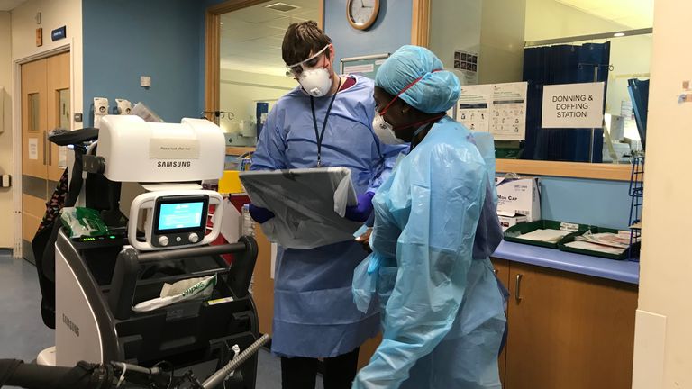 Two medics study notes while wearing their protective gear at Croydon University Hospital 