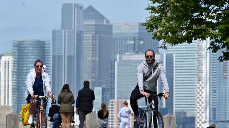 People take their daily excercise with the London skyline in the background, in Greenwich Park, south east London on April 25, 2020, during the national lockdown due to the novel coronavirus COVID-19 pandemic. - Prime Minister Boris Johnson is expected to return to work soon after his recovery from COVID-19, as pressure mounts on his government to explain how to get Britain out of lockdown. (Photo by JUSTIN TALLIS / AFP) (Photo by JUSTIN TALLIS/AFP via Getty Images)
