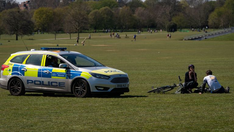 Police move on sunbathers in Regents Park, London, as the UK continues in lockdown