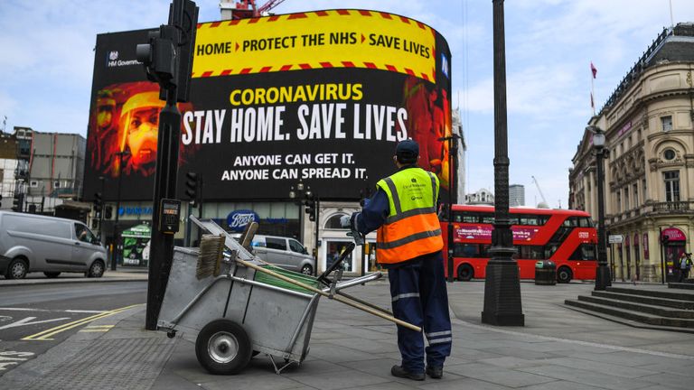 A street cleaner in empty Piccadilly Circus in London