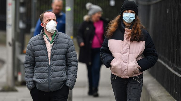 EDINBURGH, SCOTLAND - APRIL 17: Members of the public wear masks as the walk near the Mound during the coronavirus pandemic  on April 17, 2020 in Edinburgh, Scotland. The Coronavirus (COVID-19) pandemic has spread to many countries across the world, claiming over 120,000 lives and infecting over 2 million people. (Photo by Jeff J Mitchell/Getty Images)