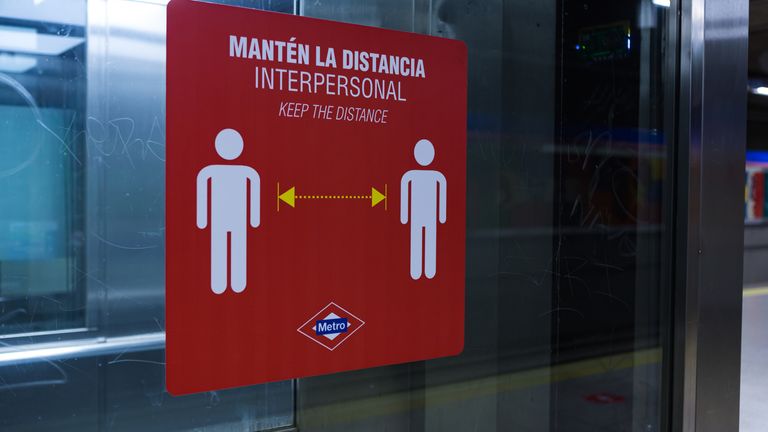 Signs on the metro in Madrid warn people to keep their distance