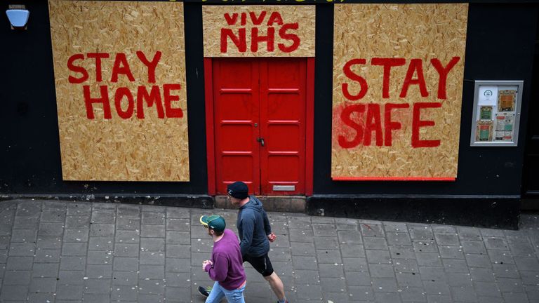 Members of the public walk past a sign on a restaurant in Victoria Street during the Coronavirus crisis on April 16, 2020 in Edinburgh