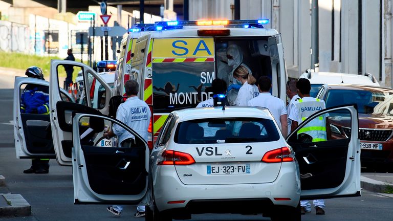 Medical staff carry a patient infected with the novel coronavirus (Covid-19) in an emergency vehicle at the Saint-Jean train station in Bordeaux,