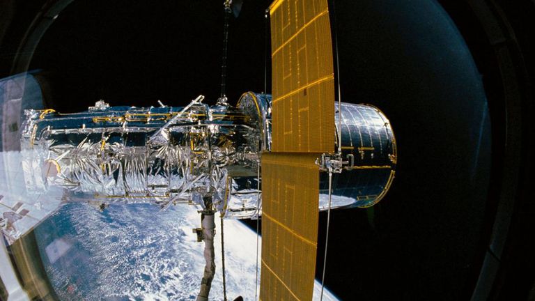 The Hubble Space Telescope being deployed from the cargo bay of space shuttle Discovery, with one of its two solar array panels deployed. Pic: NASA
