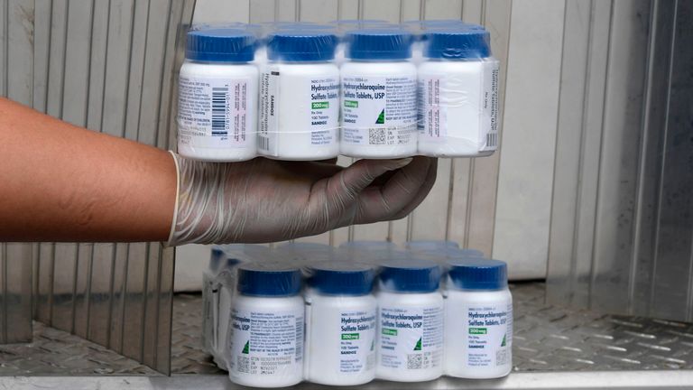 A Salvadoran Health Ministry worker holds a package of bottles of Hydroxychloroquine pills to be distributed in hospitals in San Salvador on April 21, 2020, amid the COVID-19 coronavirus outbreak