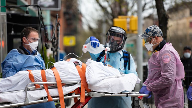 Fire Department of New York medical staff attend to an patient experiencing difficulty breathing outside an apartment