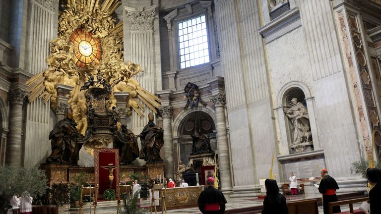 A general view shows Pope Francis (Rear C) and attendees during Palm Sunday mass behind closed doors at the Chair of Saint Peter in St. Peter&#39;s Basilica mass on April 5, 2020 in The Vatican, during the lockdown aimed at curbing the spread of the COVID-19 infection, caused by the novel coronavirus. (Photo by Alberto PIZZOLI / POOL / AFP) (Photo by ALBERTO PIZZOLI/POOL/AFP via Getty Images)
