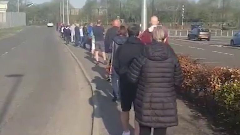 Customers join a long line waiting to get into reopened B&Q