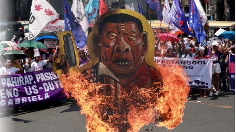 An effigy of Philippine President Rodrigo Duterte is burned during a protest on International Women&#39;s Day in Manila, Philippines, March 8, 2020. REUTERS/Eloisa Lopez