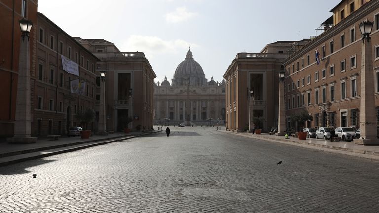 A solitary walker can be seen on a road leading to St Peter&#39;s Cathedral in the Italian capital                                                                                                                                                                                      