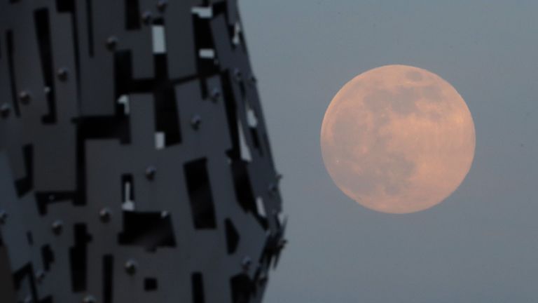 A pink supermoon is seen over the Kelpies sculpture in Falkirk