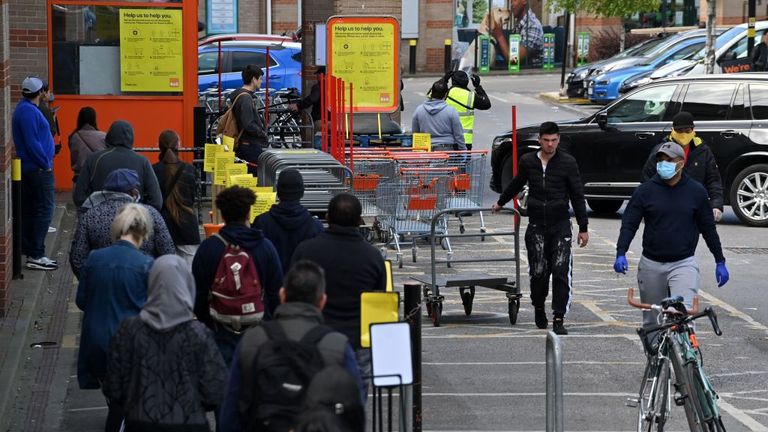 Customers queue outside the B&Q Warehouse, which has reopened after more than a month&#39;s closure, in south west London on April 25, 2020, during the national lockdown due to the novel coronavirus COVID-19 pandemic. - Prime Minister Boris Johnson is expected to return to work soon after his recovery from COVID-19, as pressure mounts on his government to explain how to get Britain out of lockdown. (Photo by JUSTIN TALLIS / AFP) (Photo by JUSTIN TALLIS/AFP via Getty Images)
