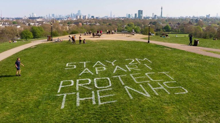 The Royal Parks charity and Camden Council have written the government&#39;s lockdown message on Primrose Hill in London. Pic: Greywolf