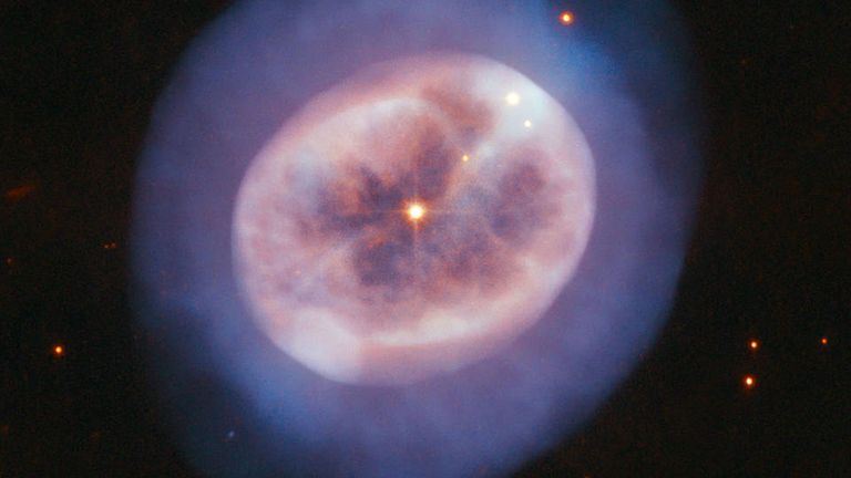 A vast orb of gas in space, cast off by an aging star named NGC 2022, captured by the Hubble Space Telescope. Pic: NASA