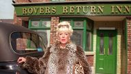 Bet Lynch (Julie Goodyear) in front of the Coronation Street pub, the Rovers Return, in 1995