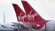 Tailfins of parked Virgin Atlantic passenger aircraft are pictured on the apron at Heathrow Airport