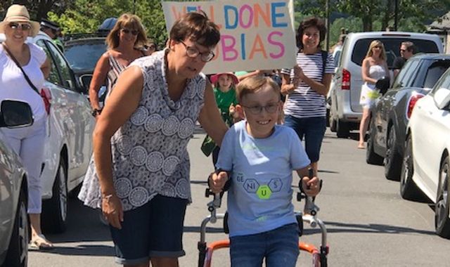 Tobias Weller: Boy with cerebral palsy raises £40,000 as he completes marathon in walker