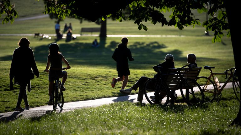 People relax and exercise in Primrose Hill park in central London, as the UK continues in lockdown to help curb the spread of the coronavirus.