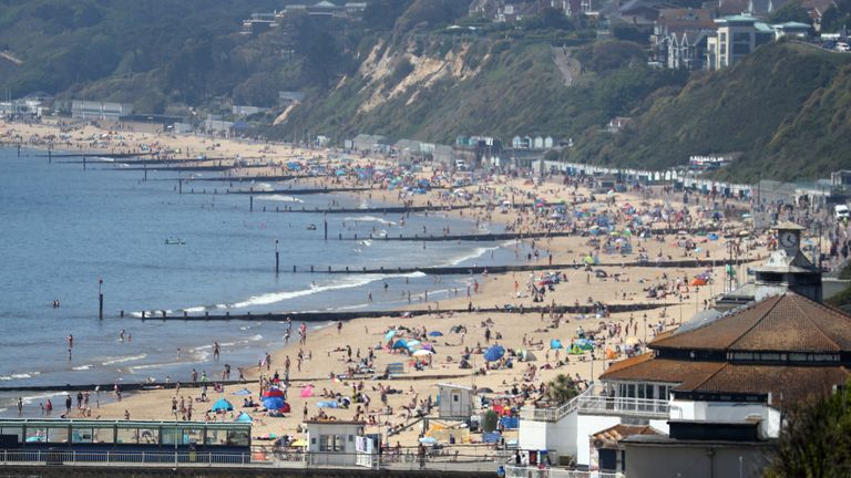 People enjoy the hot weather at Bournemouth beach in Dorset, as people flock to parks and beaches with lockdown measures eased.