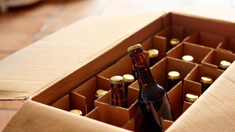 Unpacking a package of beer bottles from different breweries. Craft Beer from foreign countries or national micro breweries are hardly available in most regular stores. Online shops offer Craft beer or a selection of special beer and deliver it.