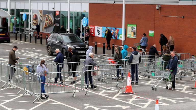 Members of the public observe social distancing measures whilst they queue for Asda in Grantham, Lincolnshire as the UK continues in lockdown to help curb the spread of the coronavirus. PA Photo. Picture date: Saturday March 28, 2020. See PA story HEALTH Coronavirus. Photo credit should read: Mike Egerton/PA Wire