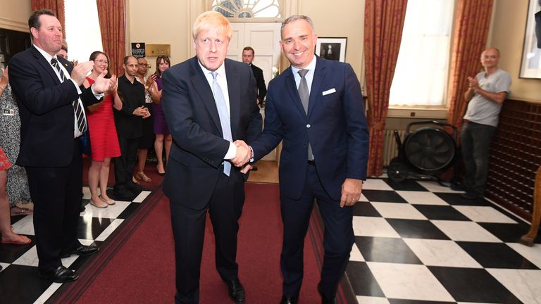 Boris Johnson shaking hands with Sir Mark Sedwill as he enters Number 10 for the first time as Prime Minister. Dominic Cummings is seen in the background on the right