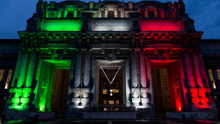 Central Station is illuminated with the colours of the Italian flag during the coronavirus pandemic on May 01, 2020 in Milan, Italy