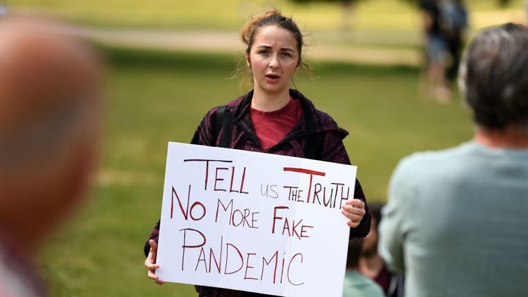 A woman holds a placard at an anti-coronavirus lockdown demonstration in Hyde Park in London on May 16, 2020, following an easing of lockdown rules in England during the novel coronavirus COVID-19 pandemic. - Fliers advertising &#39;mass gatherings&#39; organised by the UK Freedom Movement to oppose the government lockdown measures and guidelines put in place to halt the spread of coronavirus in parks around the UK calling for attendees to bring a picnic and music have been circulating on social media. 