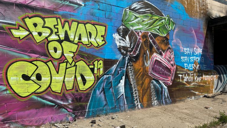 A mural warns residents of the danger of coronavirus disease