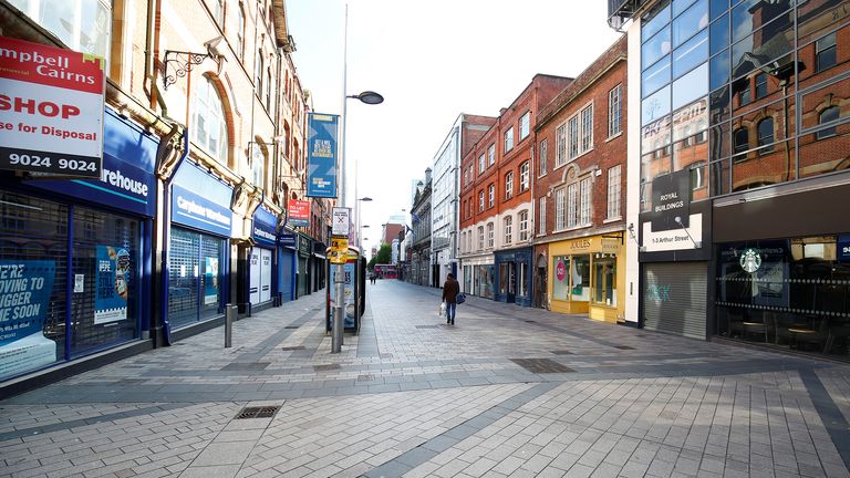 A man walks down a street in central Belfast, following the outbreak of the coronavirus disease (COVID-19), Belfast, Northern Ireland, May 4, 2020. REUTERS/Jason Cairnduff