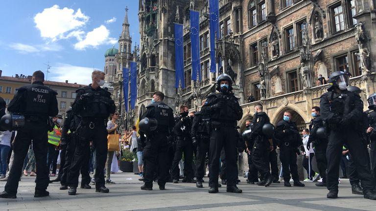 Police officers attend as protesters gather in Marienplatz