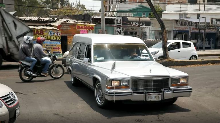 Another hearse arrives carrying a coffin at a crematorium