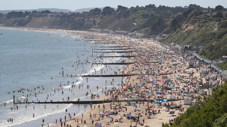 People enjoy the hot weather on Durley and Alum Chine beaches in Dorset, following the introduction of measures to bring the country out of lockdown.