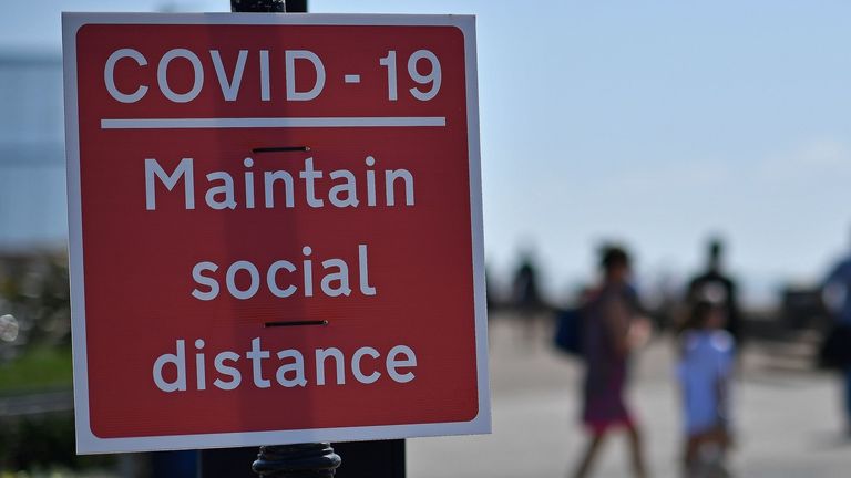 Signs advise beachgoers arriving at the seafront to &#39;Maintain Social Distance due to COVID-19", on the promenade in Southend-on-Sea, south east England on May 25, 2020, after lockdown restrictions, originally put in place due the COVID-19 pandemic, were lifted earlier this month. - British Prime Minister Boris Johnson on Sunday backed top aide Dominic Cummings despite mounting pressure from within his own party to sack him over claims he broke coronavirus lockdown regulations. (Photo by Ben STAN