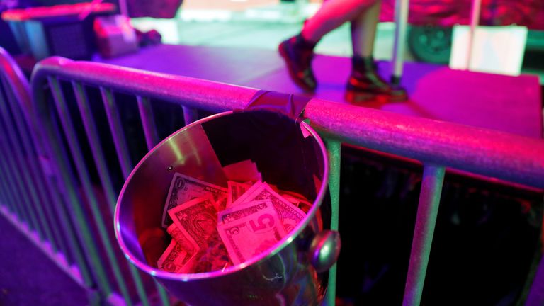 Tips are collected in a bucket at the drive thru strip club 