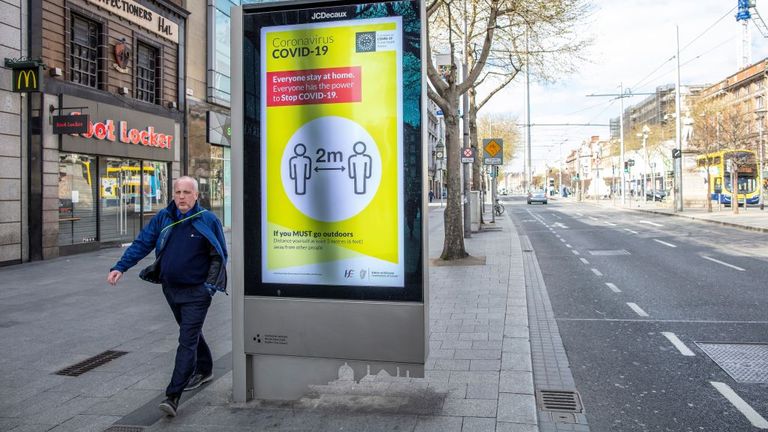 A man walks thought Dublin while lockdown measures are in place