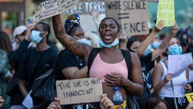 People hold placards as they join a spontaneous Black Lives Matter march through central London to protest the death of George Floyd in Minneapolis and in support of the demonstrations in North America on May 31, 2020 in London, England