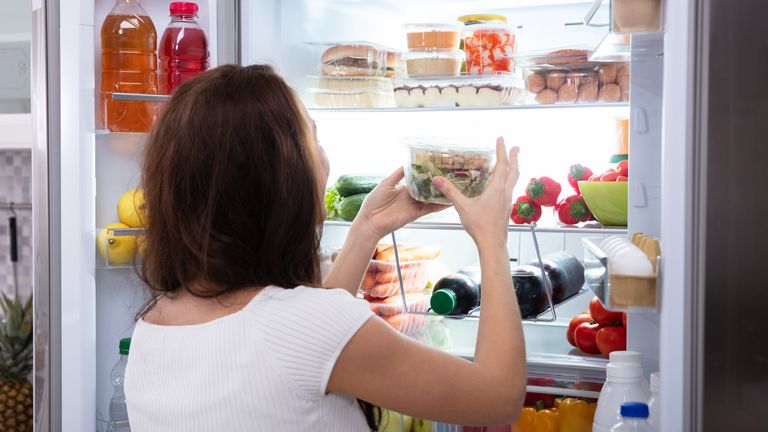 Woman looking in fridge