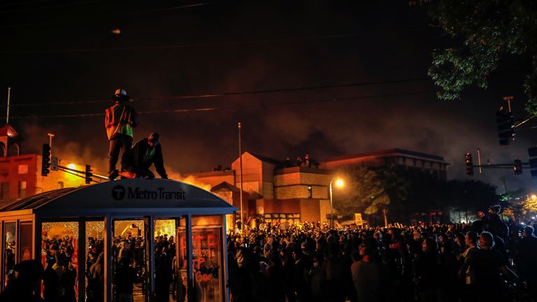 Protesters gathered around a police station in Minneapolis after the entrance was set on fire