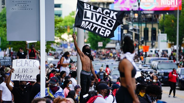 A man waves a Black Lives Matter flag during a protest over the Minneapolis death of George Floyd while in police custody outside CNN Center on May 29, 2020 in Atlanta, Georgia. (Photo by Elijah Nouvelage/Getty Images)