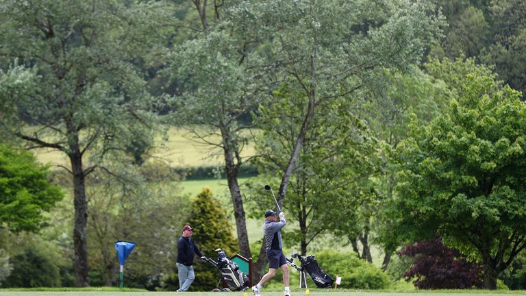 A golfer tees off at Wells Golf Club in Somerset, England