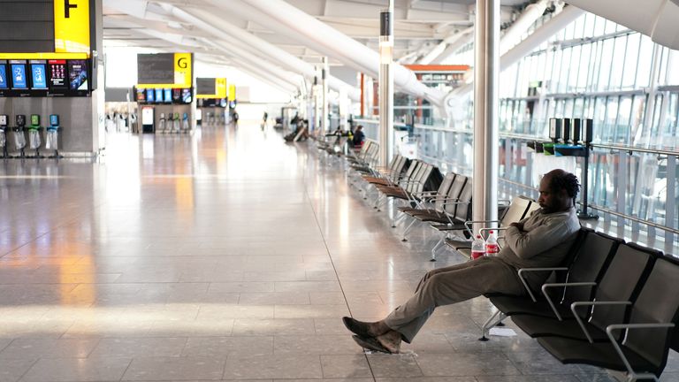 People are seen sleeping at Heathrow airport