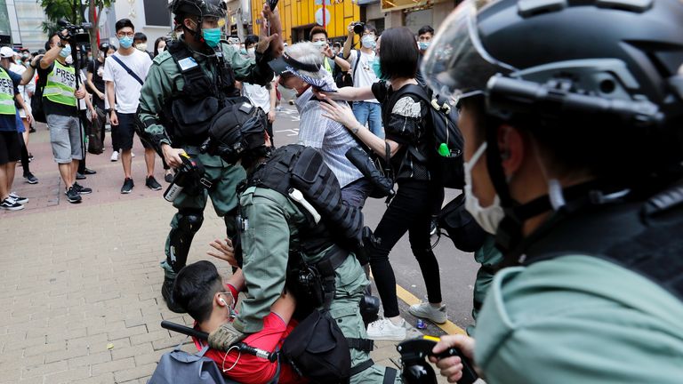 Anti-government demonstrators scuffle with riot police ahead of the bill being approved