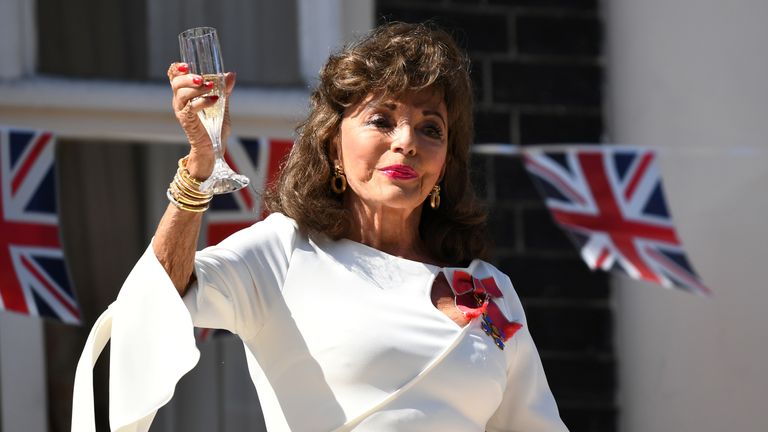 Dame Joan Collins led a toast to veterans from her London balcony