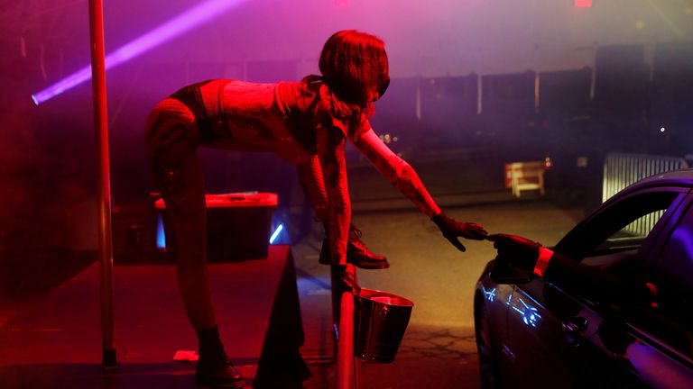 Motorists can watch the dancers perform before collecting their food 